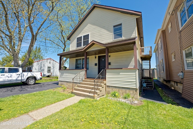 view of front of property with a porch, stairway, and a front yard