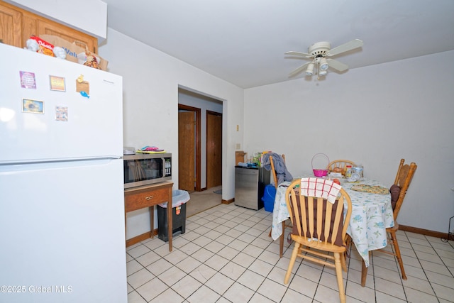 dining area with ceiling fan and baseboards