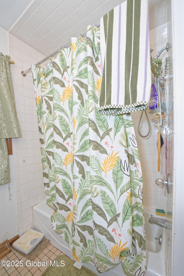 full bathroom featuring tile walls and shower / bathtub combination with curtain