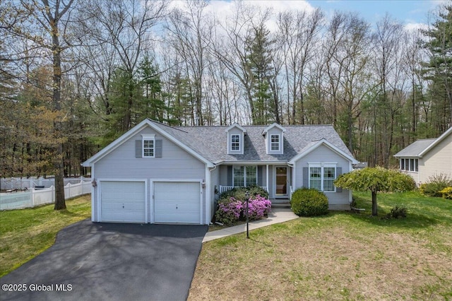 cape cod house with a garage, a front lawn, aphalt driveway, and fence