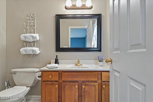 half bathroom featuring toilet and vanity