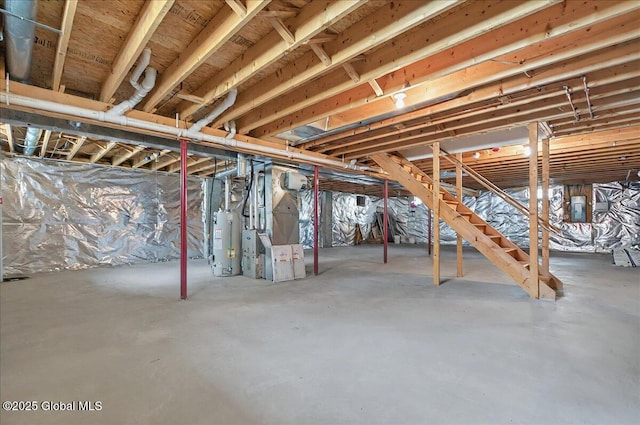 unfinished below grade area featuring heating unit, water heater, and electric panel