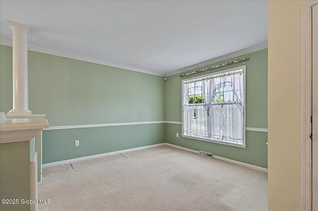 carpeted empty room featuring crown molding, baseboards, ornate columns, and visible vents