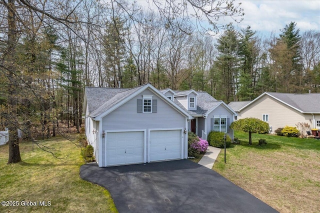 view of front of property featuring a garage, driveway, and a front yard
