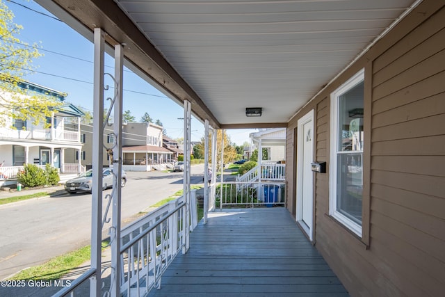deck with a residential view and covered porch