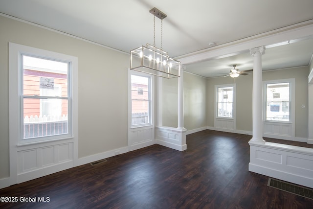 unfurnished dining area with dark wood-style flooring, ornate columns, and visible vents