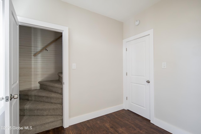 interior space featuring baseboards and wood finished floors