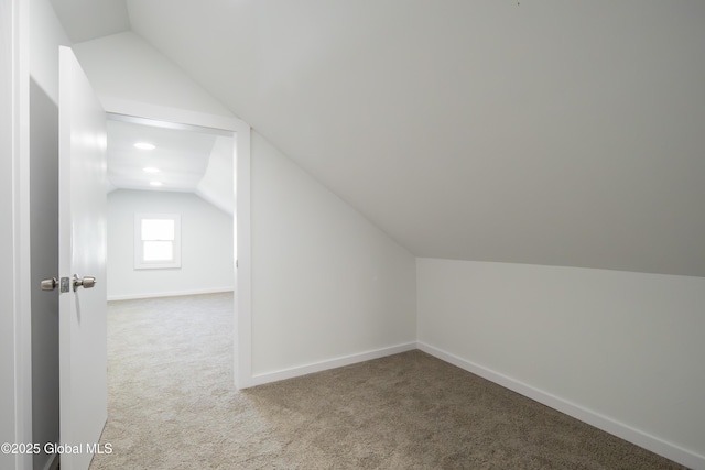 bonus room with baseboards, carpet, and lofted ceiling