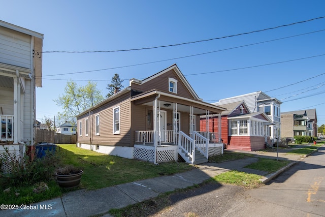 view of front of house featuring a porch and a front lawn