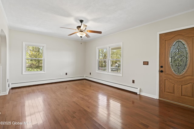 foyer with baseboard heating, a ceiling fan, hardwood / wood-style flooring, and a wealth of natural light