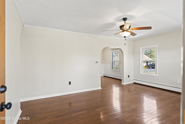 unfurnished room featuring arched walkways, ceiling fan, baseboard heating, and dark wood-style floors