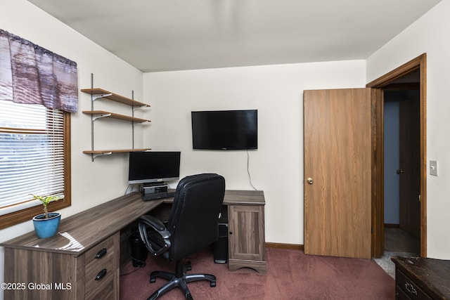 home office featuring baseboards and dark carpet