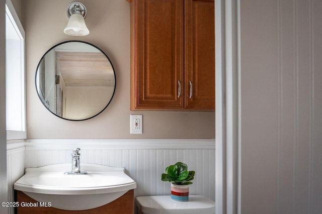 bathroom featuring a sink and wainscoting