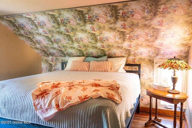 bedroom with baseboards and wood finished floors
