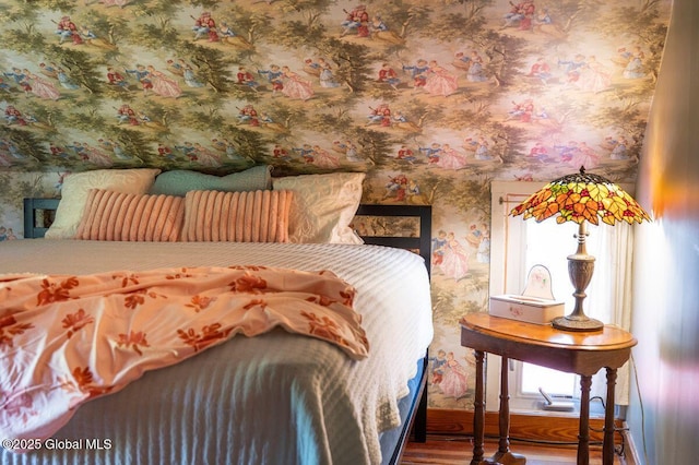 bedroom featuring wallpapered walls and baseboards