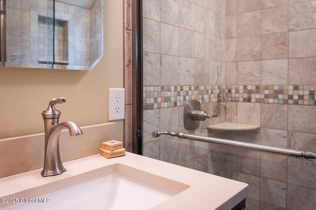 bathroom with vanity and tiled shower