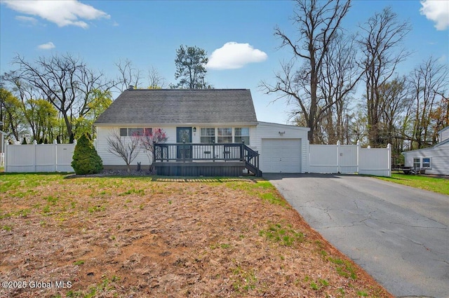 11 Red Fox Dr, Colonie, NY 12205 - cape cod-style house featuring a wooden deck, a gate, a garage, fence, and aphalt driveway