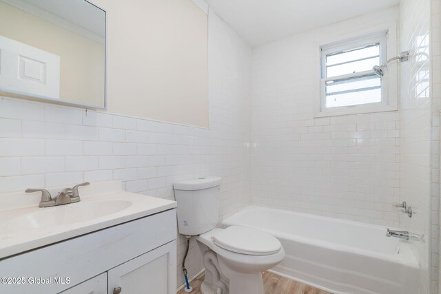 5 Barney St, Schenectady, NY 12307 - bathroom with tile walls, wood finished floors, vanity, toilet, and tub / shower combination