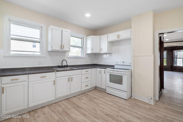 5 Barney St, Schenectady, NY 12307 - kitchen featuring a sink, light wood finished floors, white electric range oven, white cabinetry, and a wealth of natural light
