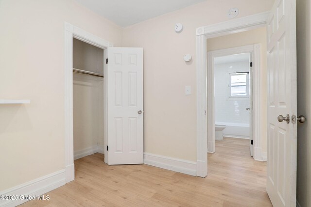 5 Barney St, Schenectady, NY 12307 - unfurnished bedroom featuring baseboards, light wood finished floors, and a closet