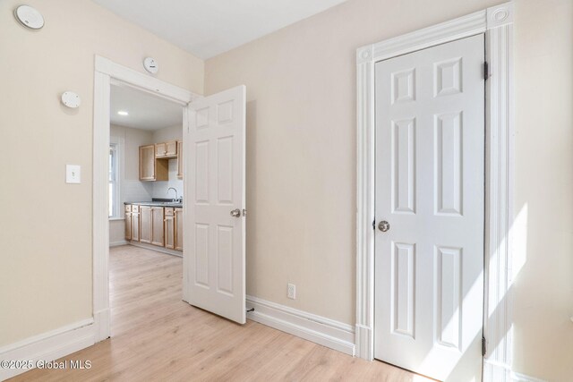 5 Barney St, Schenectady, NY 12307 - hallway with a sink, baseboards, and light wood-style flooring