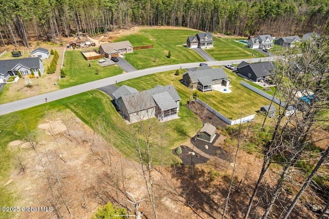 bird's eye view featuring a residential view and a wooded view