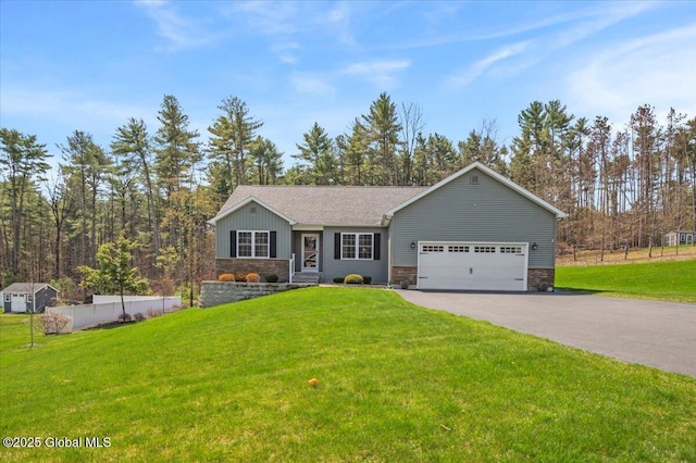 single story home featuring an attached garage, a front lawn, stone siding, and aphalt driveway