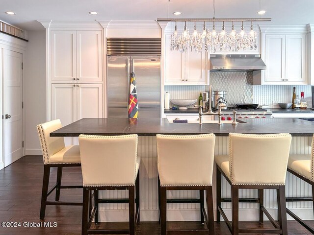5A6 Sagamore Rd, Bolton, NY 12814 - kitchen with dark countertops, built in refrigerator, tasteful backsplash, and under cabinet range hood