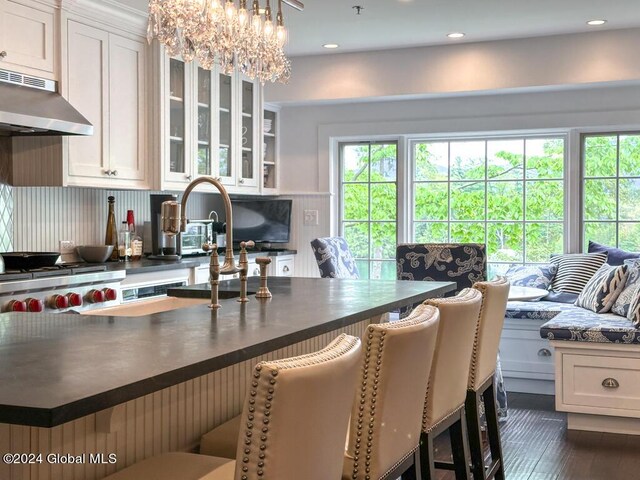 5A6 Sagamore Rd, Bolton, NY 12814 - kitchen featuring under cabinet range hood, dark wood-style flooring, dark countertops, and glass insert cabinets