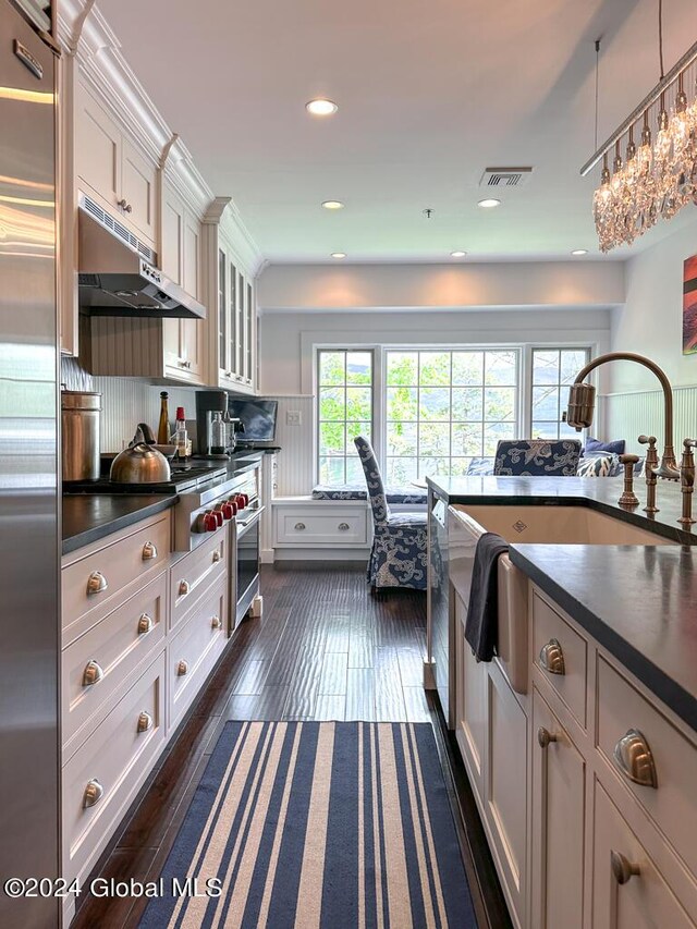 5A6 Sagamore Rd, Bolton, NY 12814 - kitchen featuring dark countertops, dark wood-type flooring, under cabinet range hood, visible vents, and glass insert cabinets