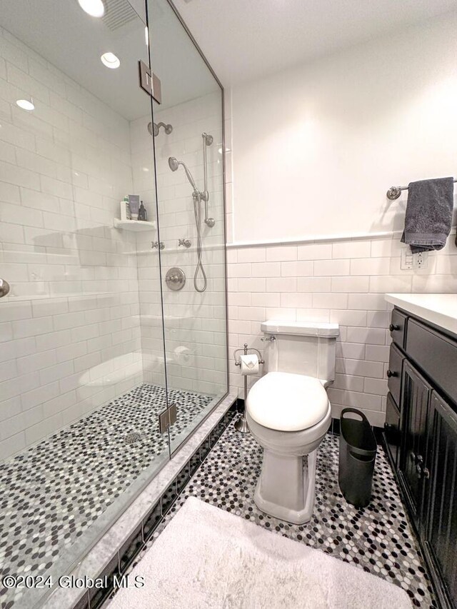 5A6 Sagamore Rd, Bolton, NY 12814 - full bath featuring wainscoting, vanity, toilet, tile walls, and a shower stall
