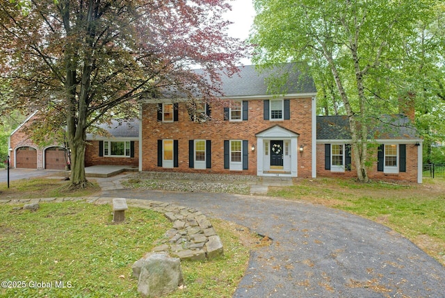 14 Birch Hill Rd, Albany, NY 12211 - colonial house with driveway, brick siding, a garage, and a shingled roof