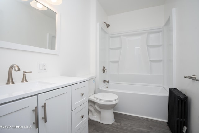 1538 Nott St, Schenectady, NY 12308 - bathroom featuring radiator heating unit, vanity, wood finished floors, toilet, and shower / tub combination