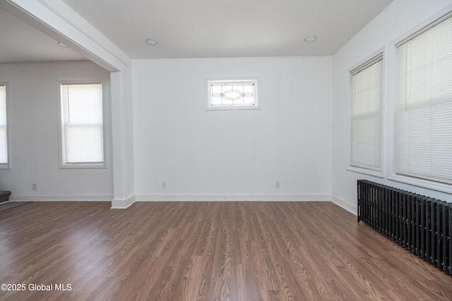 1538 Nott St, Schenectady, NY 12308 - spare room featuring radiator heating unit, dark wood-style flooring, and baseboards