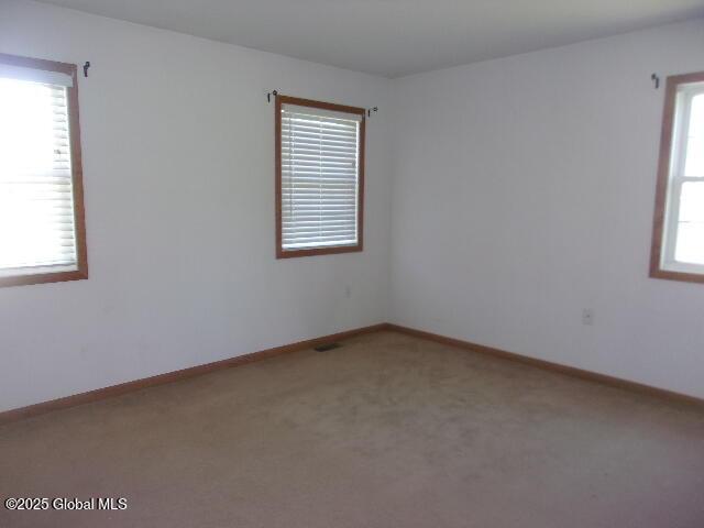 empty room with carpet floors and baseboards