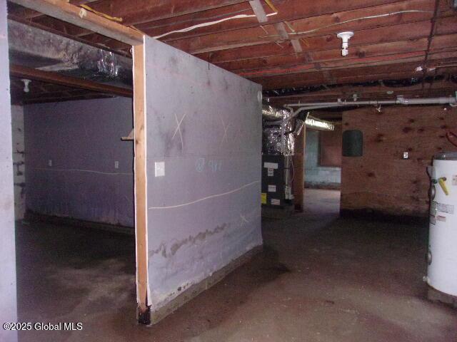 unfinished below grade area with heating unit and water heater