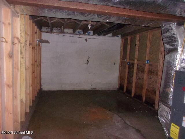 unfinished basement featuring heating unit