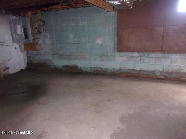 unfinished basement featuring electric panel
