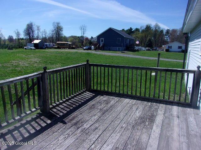 wooden terrace with a lawn