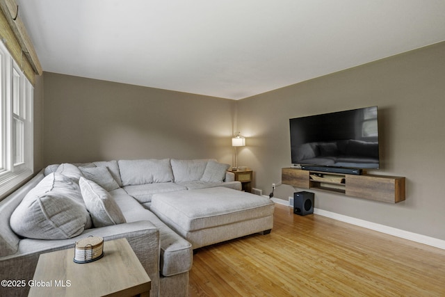 living area featuring wood finished floors and baseboards