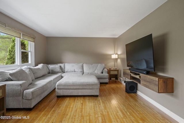 living area featuring wood-type flooring and baseboards