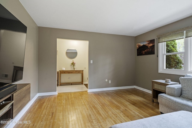 living area featuring light wood-style floors and baseboards