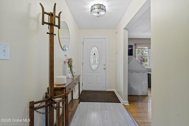 entrance foyer with wood finished floors and baseboards