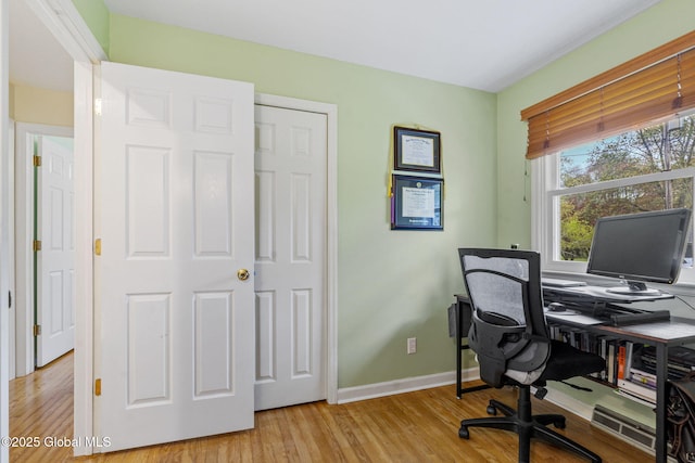 home office with wood finished floors and baseboards