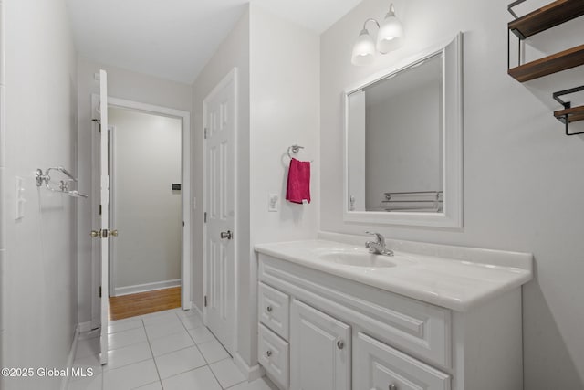 bathroom featuring tile patterned flooring, vanity, and baseboards