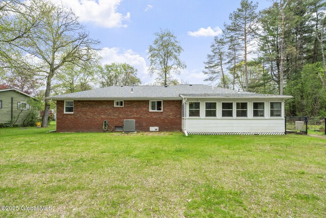 rear view of house with cooling unit and brick siding