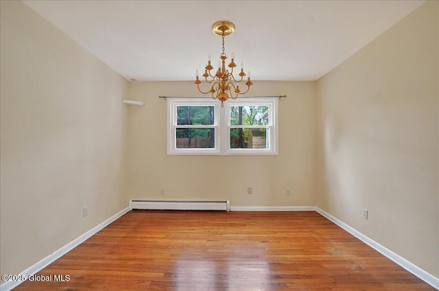 unfurnished room featuring baseboard heating, a chandelier, wood finished floors, and baseboards