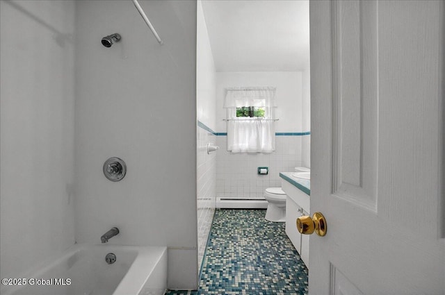 bathroom featuring baseboard heating, toilet, tile patterned flooring, vanity, and tile walls