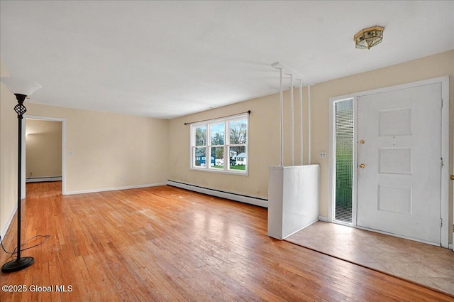 entrance foyer with a baseboard heating unit, a baseboard radiator, light wood finished floors, and baseboards