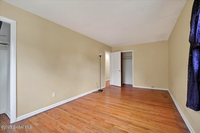 unfurnished bedroom with light wood-style floors and baseboards